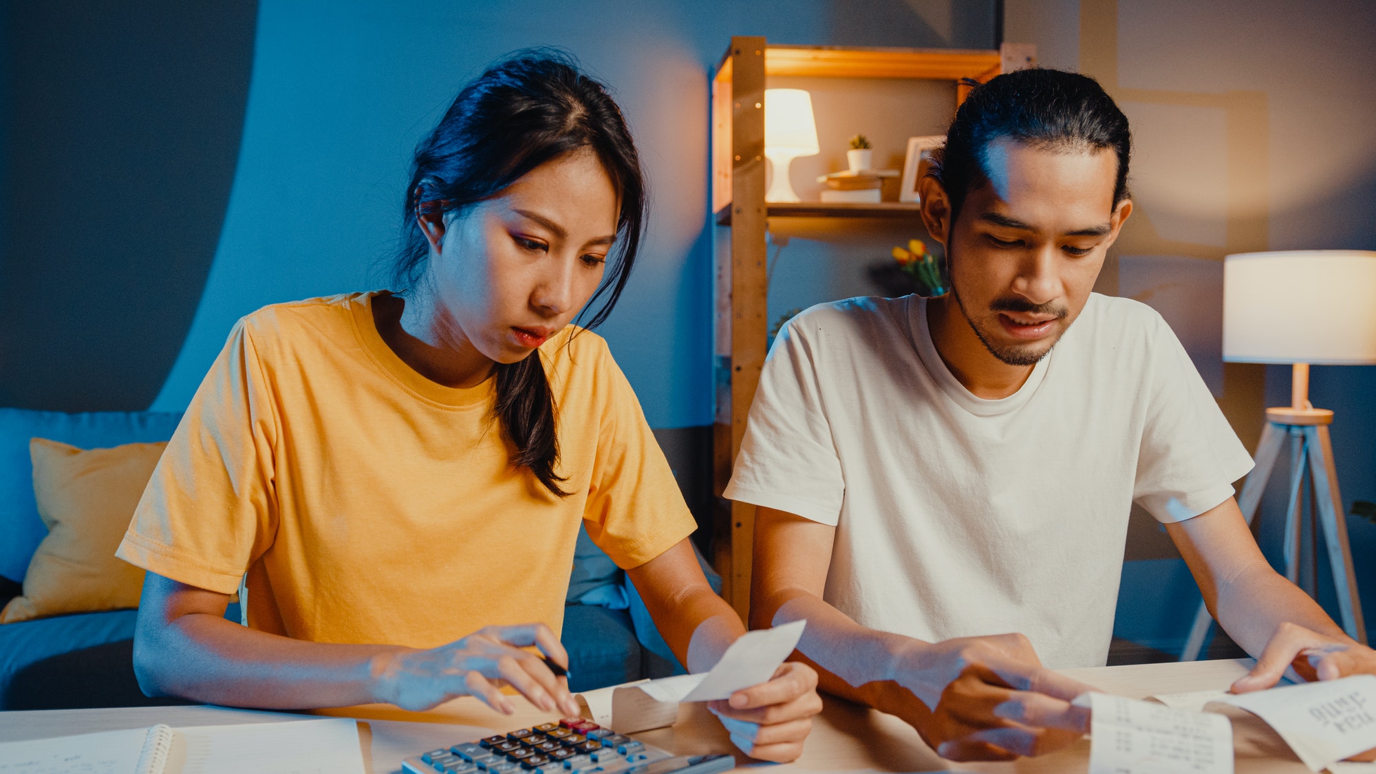 man and woman use calculator for calculate family budget, debts, expenses during financial.